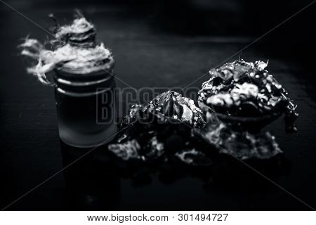 Raw Organic Amli Or Tamarind Or Imli In A Clay Bowl On Wooden Surface With Its Extracted Herbal Esse