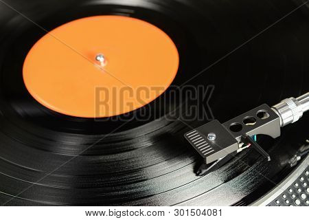 Vintage Vinyl Record With Empty Orange Label Played On Turntable With Audiophile Cartridge.