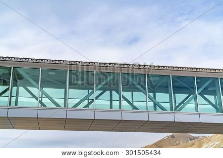 Looking Up At An Empty Skybridge With A Cloudy Blue Sky In The Background