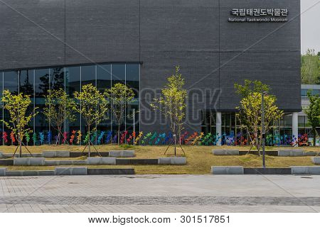 Muju,south Korea; May 1, 2019: Exterior View Of Trees And Pinwheels In Front Of National Taekwondo M