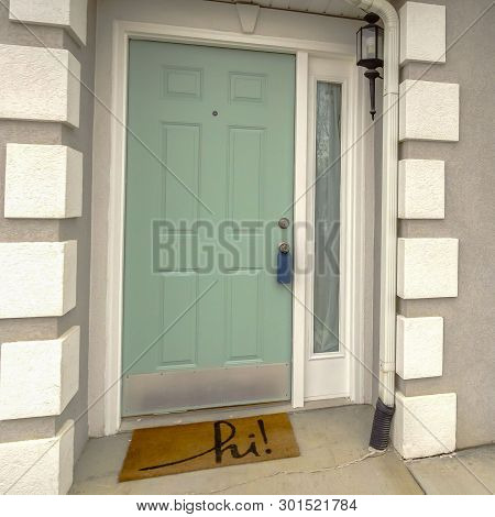 Clear Square Green Front Door With Sidelight On The Facade Of Home Viewed Against Cloudy Sky