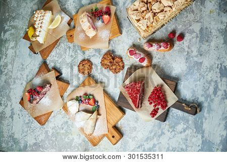 Assorted Sweet Desserts. Top View. Gray Textured Background. Beautiful Serving Dishes. Dessert. Food