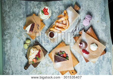 Assorted Sweet Desserts. Top View. Gray Textured Background. Beautiful Serving Dishes. Dessert. Food