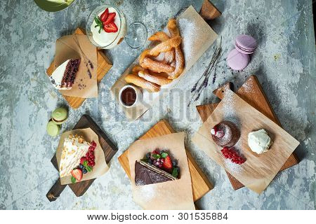 Assorted Sweet Desserts. Top View. Gray Textured Background. Beautiful Serving Dishes. Dessert. Food