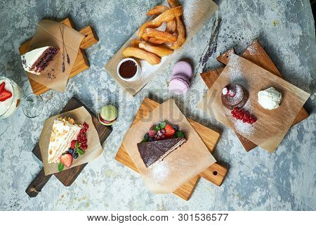 Assorted Sweet Desserts. Top View. Gray Textured Background. Beautiful Serving Dishes. Dessert. Food