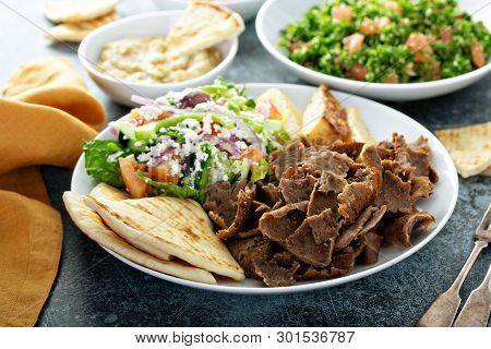 Mediterranean Food On The Table, Gyro Platter, Pita And Dips And Tabbouleh