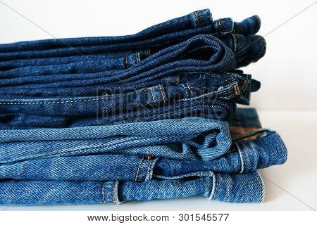 Stack Of Classic Blue Jeans On White Background