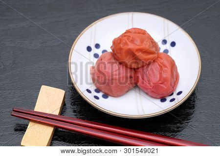 Japanese Food, Pickled Umeboshi With Cooked Rice On Black Background