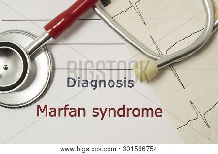 Cardiac Diagnosis Of Marfan Syndrome. On Doctor Workplace Are Red Stethoscope, Printed On Paper Ecg 