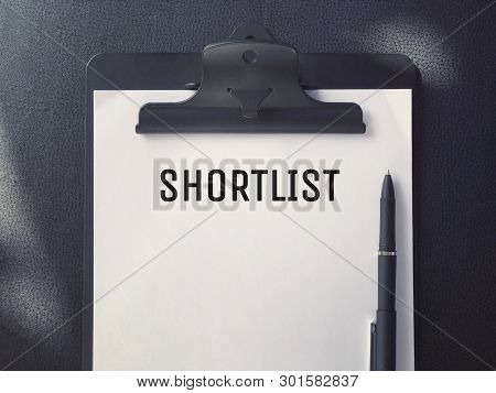 Business Or Job Hiring Concept - Top View Of A Clipboard And White Sheet With Shortlist Written On I