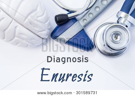Diagnosis Of Enuresis. Anatomical Brain Figure, Neurological Hammer And Stethoscope Lying On Sheet O