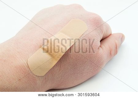 Wounded Back Of The Wrist (cut, Burn) And The Wound Is Covered With Plaster Or Band-aid. Use Of Firs