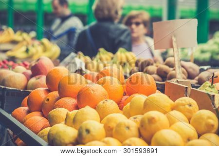 Shopping Fruit On The Marketplace. Orange And Lemon In Baskets Ready For Sale On The Marketplace In 