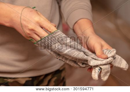 Worker Takes Off Gloves From Hands At A Construction Site.