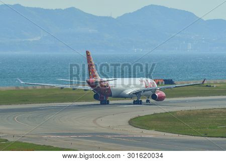 Passenger Airplane Taxiing On Runway