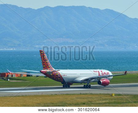 Passenger Airplane Taxiing On Runway