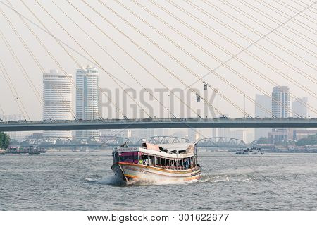 Bangkok, Thailand - March 2019: Passenger Vessel Sailing At Chao Phraya River With Rama Viii Bridge 