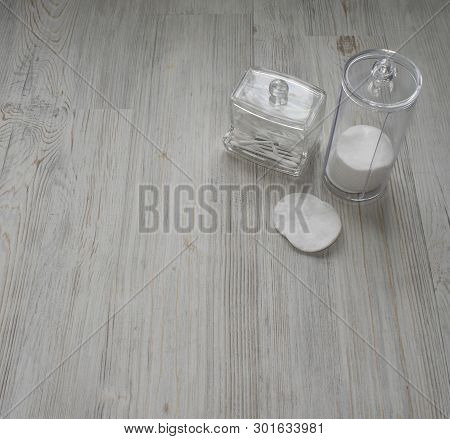 Cosmetic Flatlay On Grey Wooden Table. Beauty Set Of Plastic Containers With Q-tips And Disks. Space