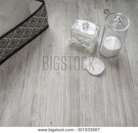 Cosmetic Flatlay On Grey Wooden Table. Beauty Set Of Box, Plastic Containers With Q-tips And Disks. 