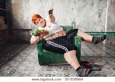 Overweight woman watches TV, bulimic, fatty
