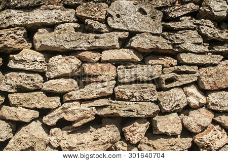 Old Rural Dry Masonry Stone Wall Closeup As Stone Background