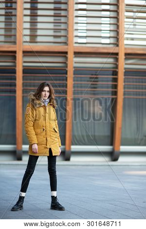 Fashion model walking and posing outdoor. Young blond caucasian woman posing winter outdoo. Beautiful girl, urban portrait.