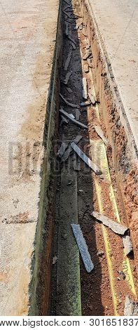 A Trench Showing A Cross Section Of A Road.