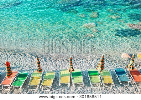 Empty Beach With Closed Umbrellas On Italian Coast