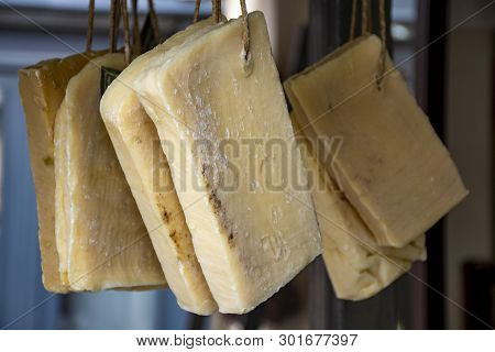 Hand Made From Natural Ingredients And Oils Soap Cutted From Blocks Hanging In Shop Close Up