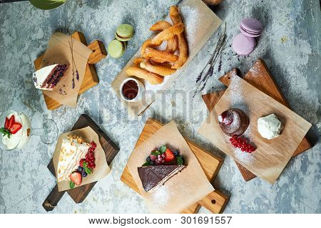 Assorted Sweet Desserts. Top View. Gray Textured Background. Beautiful Serving Dishes. Dessert. Food