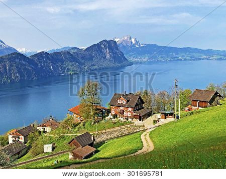 View Of Lake Lucerne Or Vierwaldstaetersee With Vitznau Settlement And Swiss Alps In The Background 