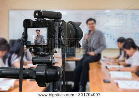 Professional Digital Mirrorless Camera On The Tripod Recording Video Blog Of Asian Teacher In The Cl