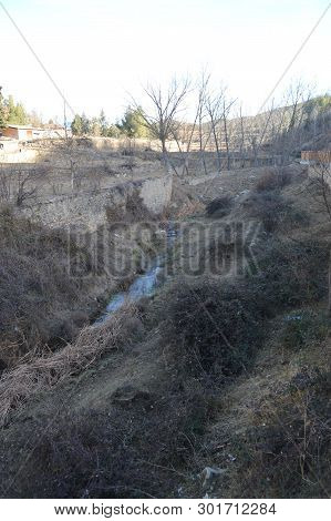 December 27, 2013. Small Creek Surrounding The Beautiful Bullring In Rubielos De Mora, Teruel, Arago