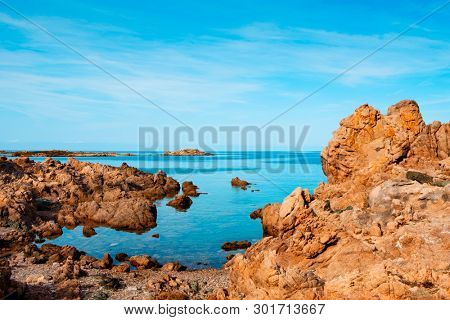 a view of the rock formations in La Tonnara, on the Southern coast of Corsica, France, with the calm Mediterranean sea in the background