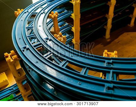 Colorful Plastic Toy Trian Tracks. Closeup To The Curving Part With Glimpse Of Light On It.