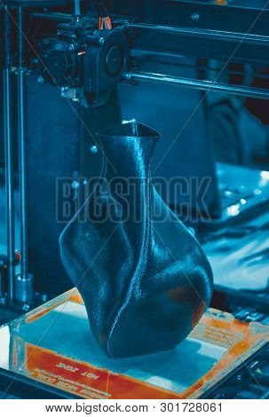 3d Printer Printing A Model In The Form Of Black Vase Close-up.