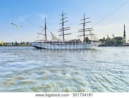 Historical Three-master Sailing Ship Leaving Hamburg Port On A Bright Sunny Day