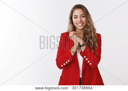 Thankful Pleased Young Gorgeous European Curly-haired Woman, Wearing Red Jacket Pressing Palms Toget