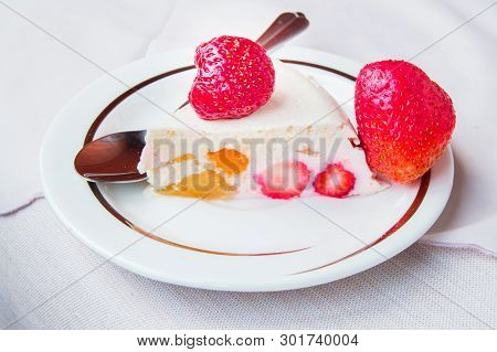 Piece Of Dessert With Strawberries And Cream On A Plate With A Spoon, A Tasty Treat, Healthy Food
