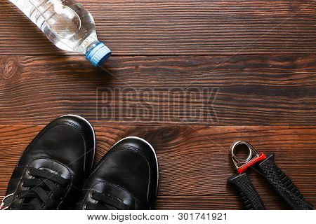 Background Sneakers Espander Water On Wooden Background