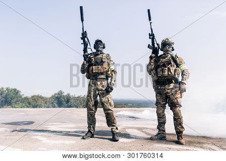 Two Armed Men In Camouflage With Sniper Gun In Hand Outdoors