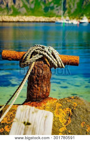 Harbor Marina Detail. Old Rusty Mooring Bollard With Rope. Bleik Village, Andoya Island, Vesteralen 