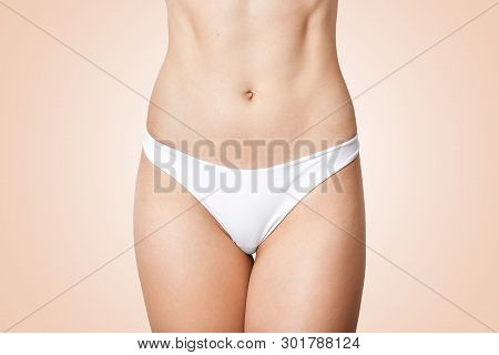 Faceless Photo Of Woman In Panties Showing Her Perfect Flat Belly, Lady Has Soft Skin, Wering White 
