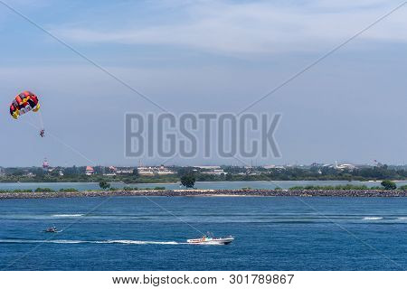 Bali, Indonesia - February 25, 2019: Outside Benoa Port. Colorful Parasailing Activity At Entrance T