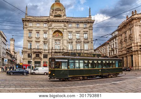 Milan, Italy - May 7, 2019: Palazzo Delle Assicurazioni Generali And The Walking Tram-restaurant In 