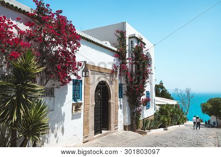 Sidi Bou Said, Tunisia - May 19, 2017: View Of The Street And Sea In The Background. Blue Sky, Copy 