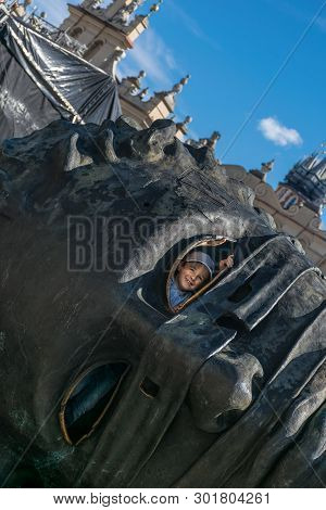 Krakow, Poland - September 23, 2018: Smiling Kid Looking Through The Eye Hole Of The Head Sculpture 