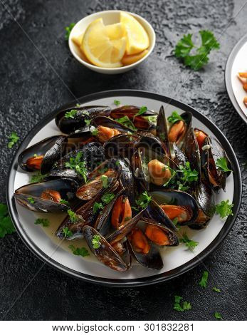 Mussels With White Wine, Garlic, Lemon And Herbs In A Plate, French Fries. Rustick Background. Seafo