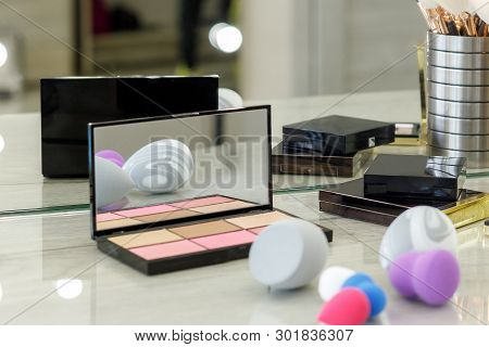 Palette With Shadows, Brushes And Sponges On The Table In The Beauty Salon