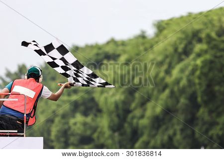 Back View Of Man Holding Checkered Race Flag